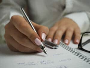 Write English words, definitions, and sentences in a vocabulary notebook